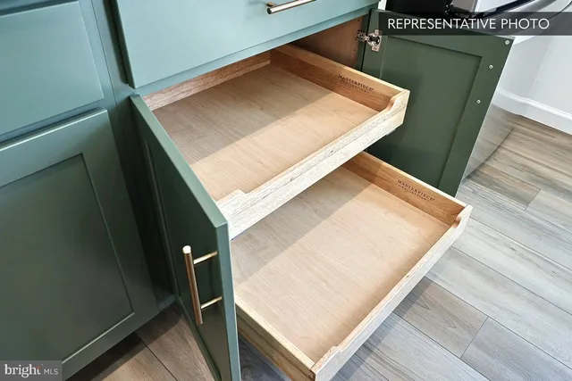 a view of a kitchen with wooden floor and a large window