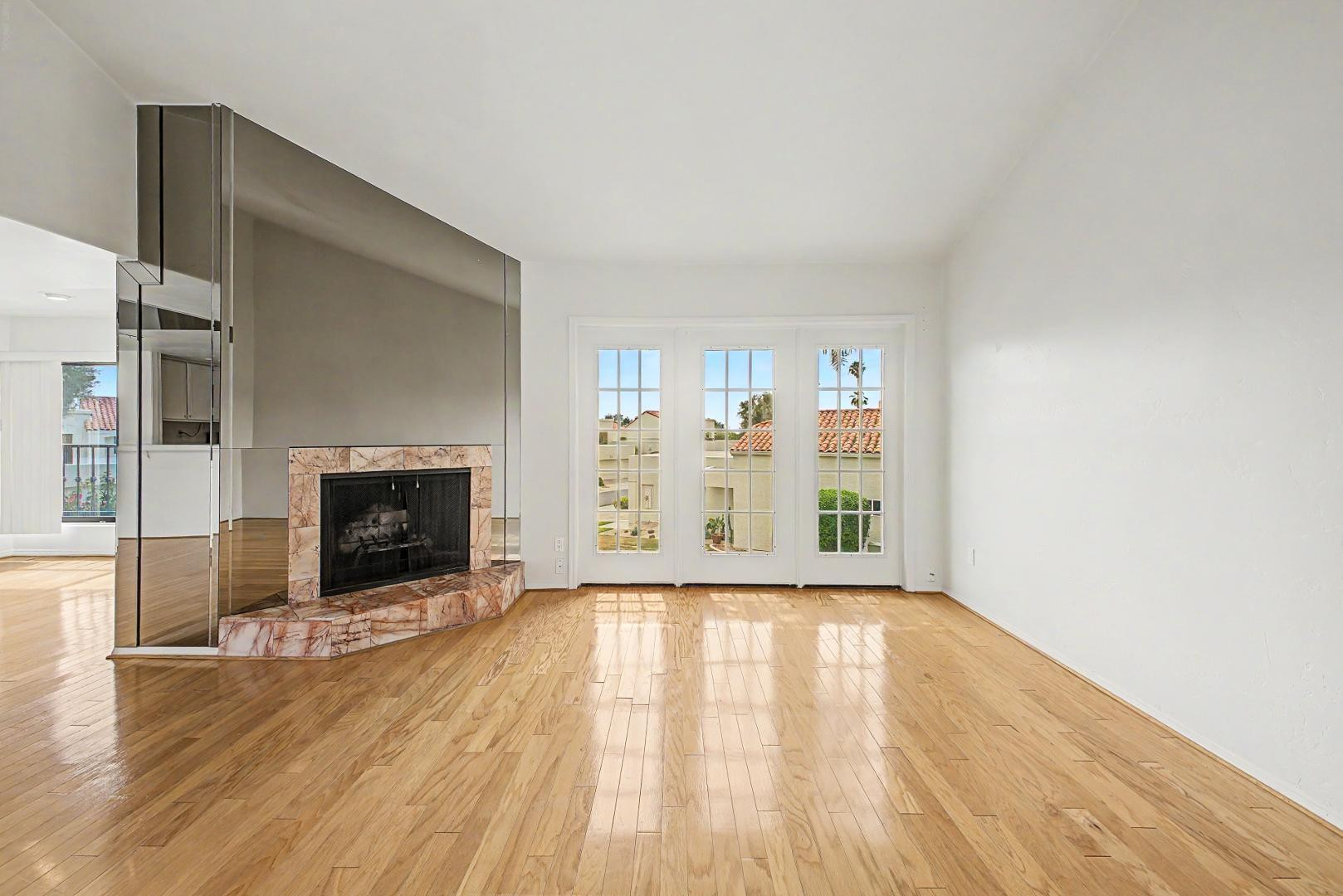5736 North 25th Street Phoenix, AZ 85016 - Photo 28 of 59 a view of an empty room with wooden floor fireplace and a window