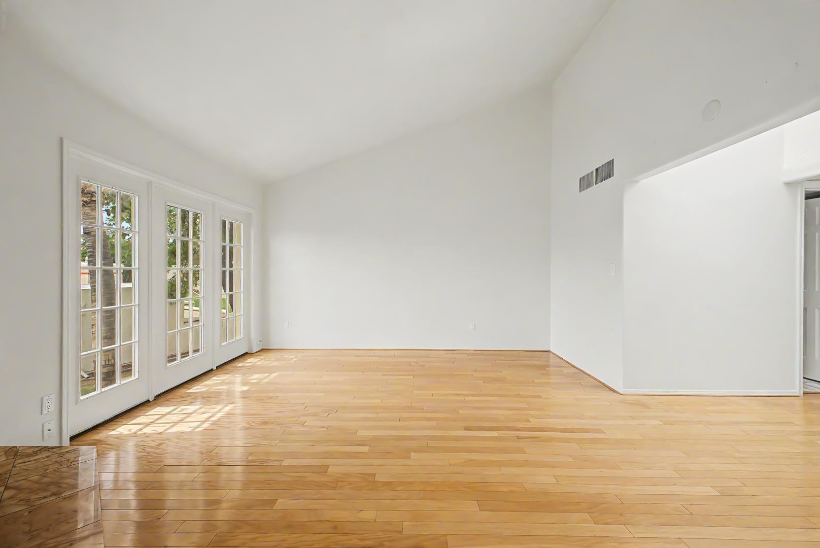 5736 North 25th Street Phoenix, AZ 85016 - Photo 30 of 59 a view of an empty room with wooden floor and a window