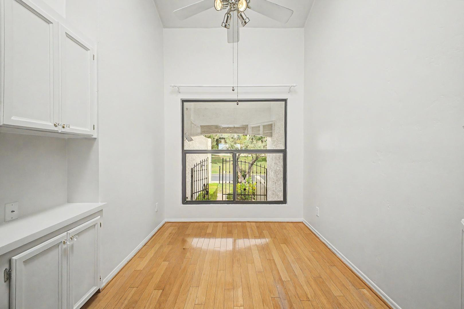 5736 North 25th Street Phoenix, AZ 85016 - Photo 35 of 59 a view of an empty room with a window and wooden floor