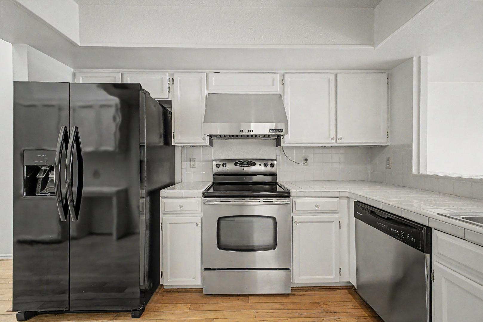 5736 North 25th Street Phoenix, AZ 85016 - Photo 6 of 59 a kitchen with a stove and a refrigerator