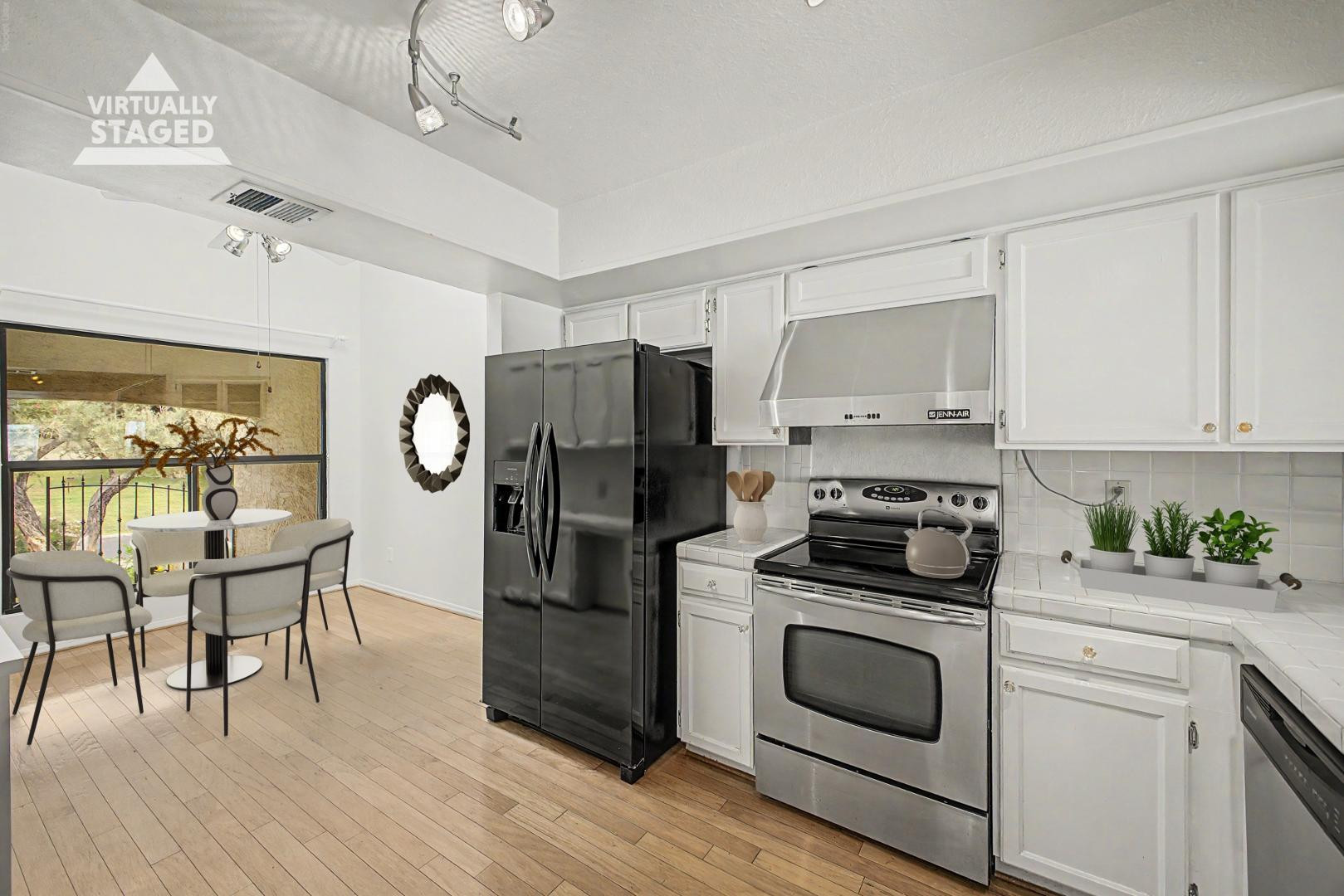 5736 North 25th Street Phoenix, AZ 85016 - Photo 7 of 59 a kitchen with a stove a refrigerator and a dining table with wooden floor