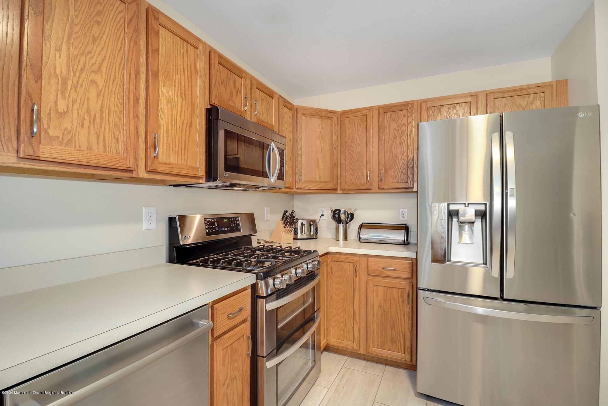 1403 Reed Road Cream Ridge, NJ 08514 - Photo 11 of 31 a kitchen with stainless steel appliances granite countertop a refrigerator stove top oven and sink with cabinets