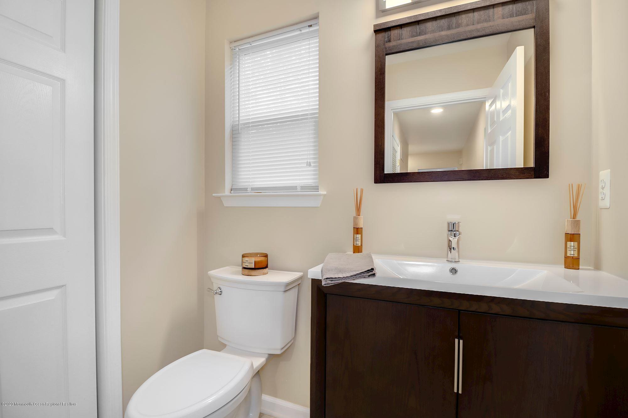 1403 Reed Road Cream Ridge, NJ 08514 - Photo 15 of 31 a bathroom with a toilet sink and mirror