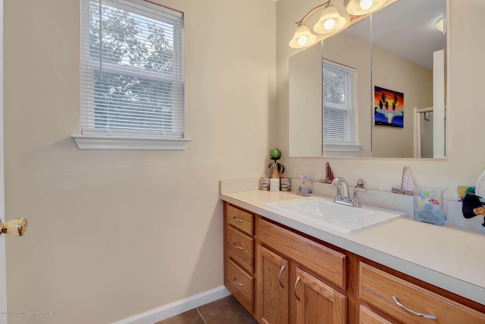 1403 Reed Road Cream Ridge, NJ 08514 - Photo 23 of 31 a bathroom with a sink a vanity and a mirror