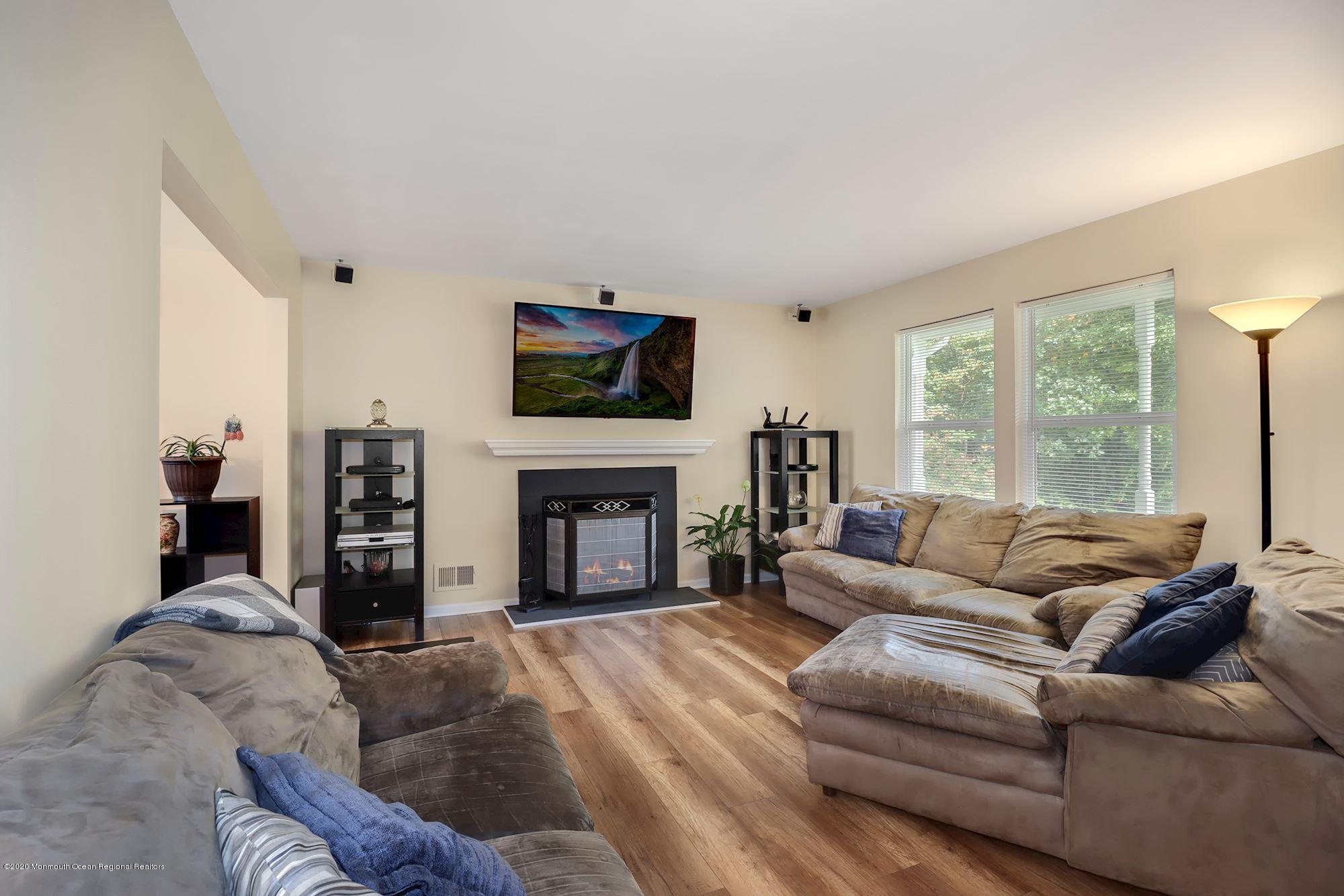 1403 Reed Road Cream Ridge, NJ 08514 - Photo 4 of 31 a living room with furniture large window and a fireplace