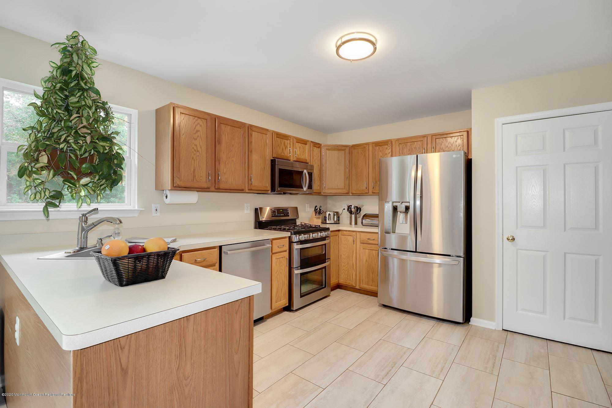 1403 Reed Road Cream Ridge, NJ 08514 - Photo 10 of 31 a kitchen with stainless steel appliances a stove a sink a refrigerator and a microwave