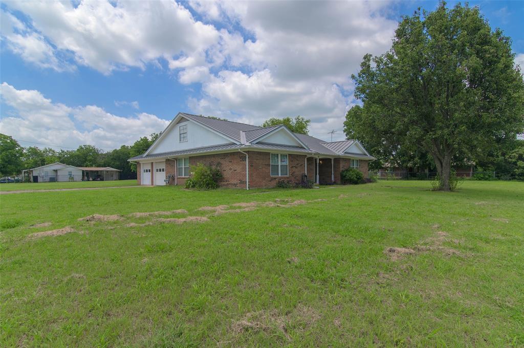 301 East 6th Street Krum, TX 76249 - Photo 26 of 29 Front and side view of this beautiful brick home on a massive corner lot.