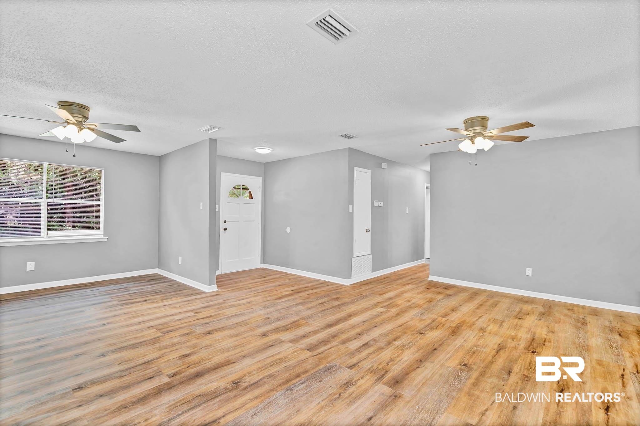 3304 Armond Drive Mobile, AL 36605 - Photo 9 of 62 Unfurnished room featuring a ceiling fan, light wood-style flooring, and a textured ceiling