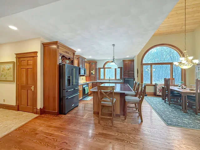 a bathroom with a glass shower door and a wooden floor