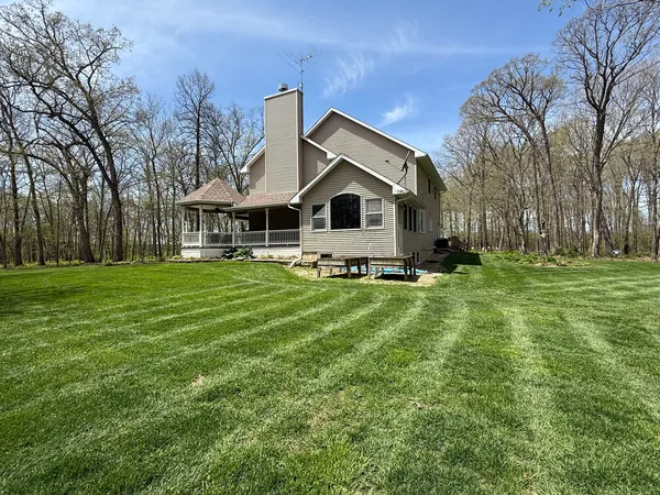 a front view of a house with a yard table and chairs