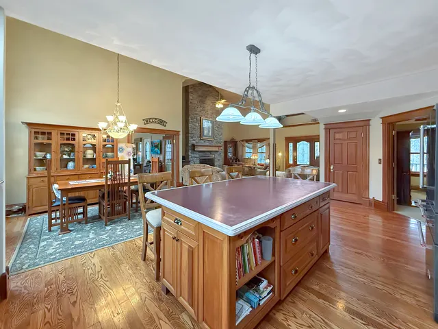 a spacious bedroom with a bed and wooden floor