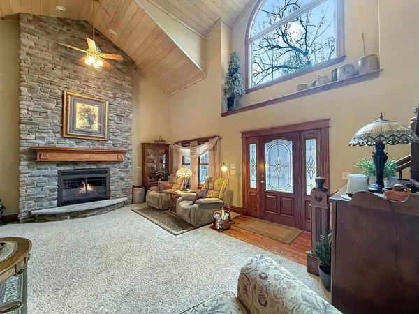 a living room with furniture a flat screen tv and a window