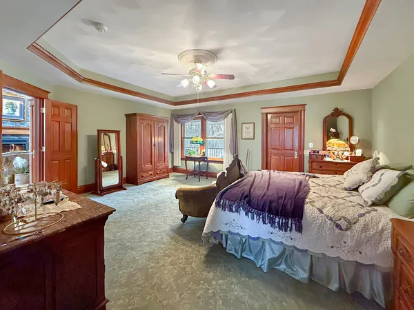 a bedroom with a bed and a dresser in it