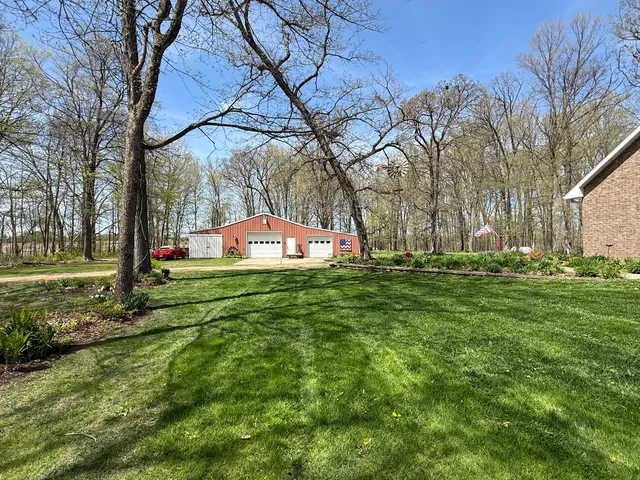 a view of a dining room with furniture a chandelier and wooden floor