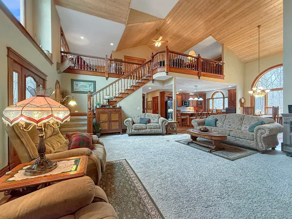 a living room with furniture a fireplace and a large window
