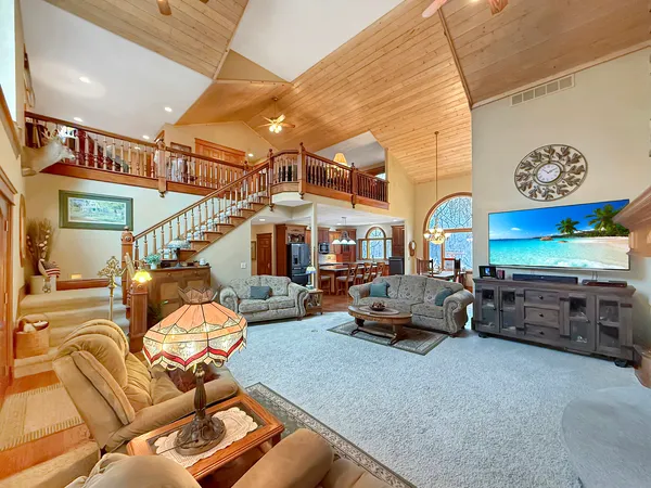 a living room with furniture a rug and a chandelier