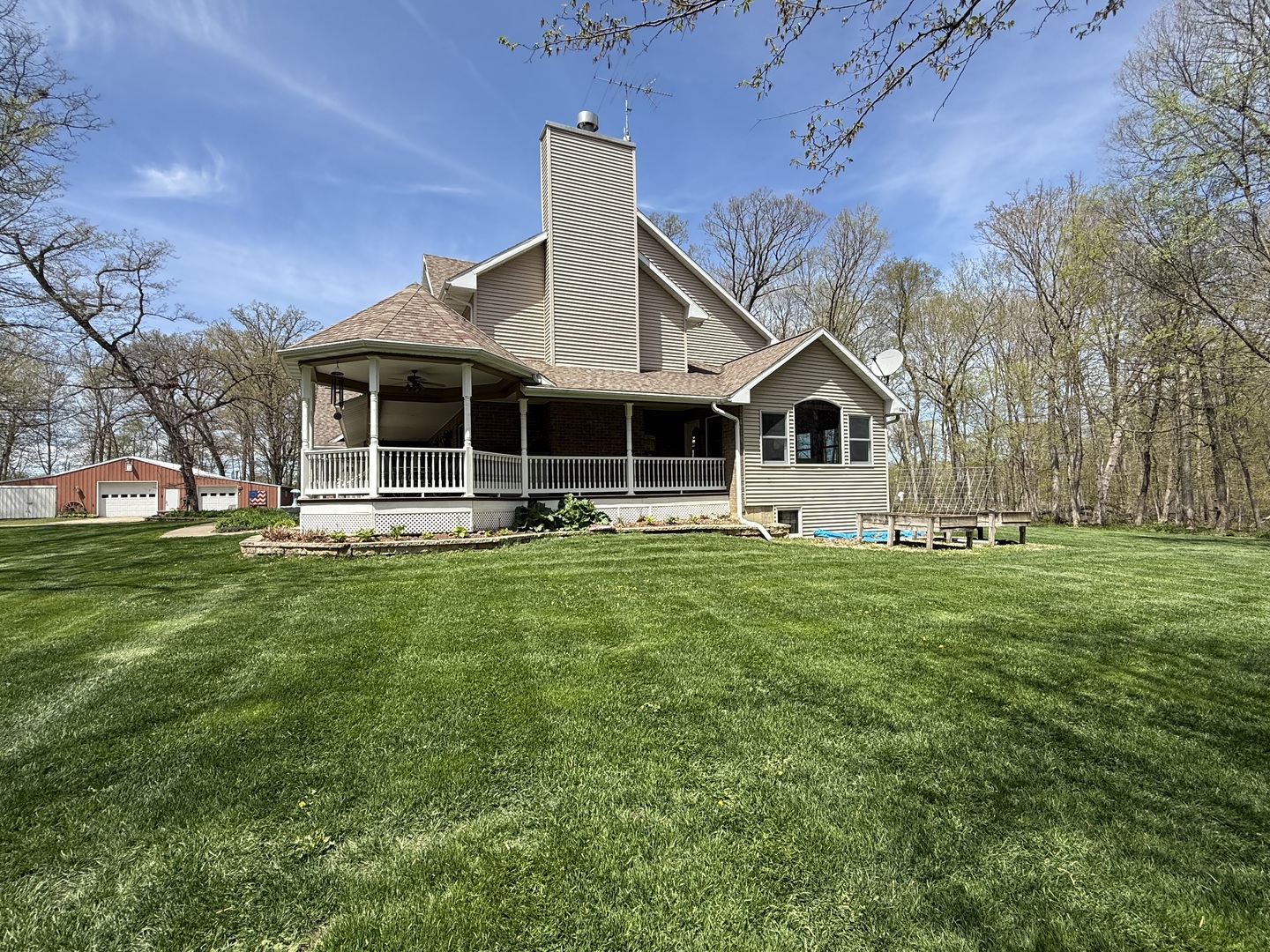 11307 Timber Lane Lena, IL 61048 - Photo 83 of 85 a front view of a house with a garden and trees