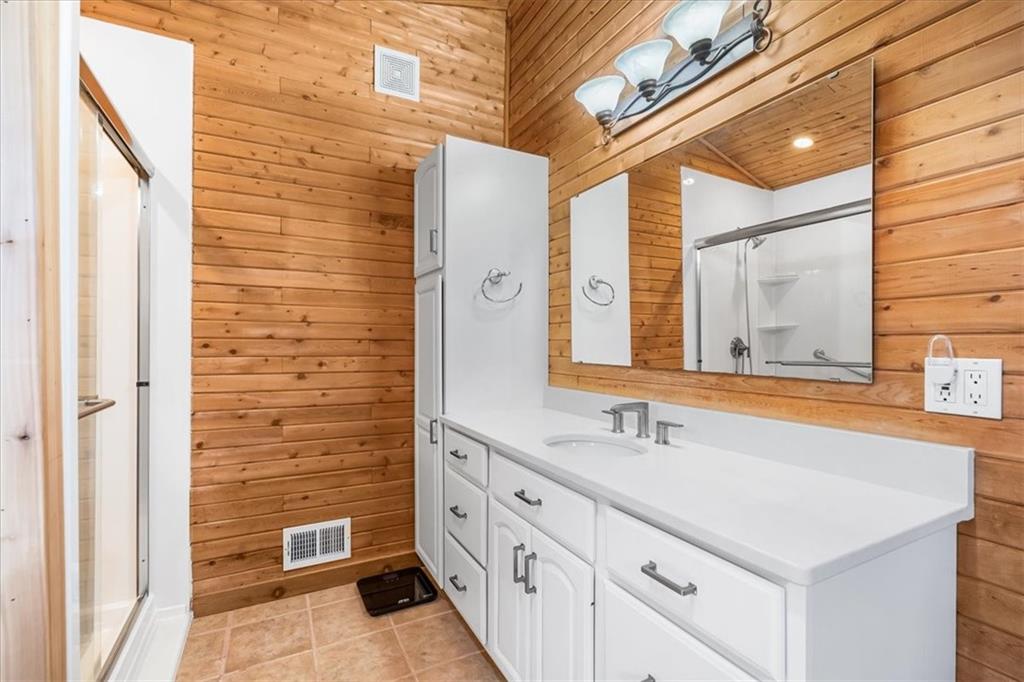 202 Reiber Road Renfrew, PA 16053 - Photo 12 of 42 a bathroom with a sink a mirror and a shower