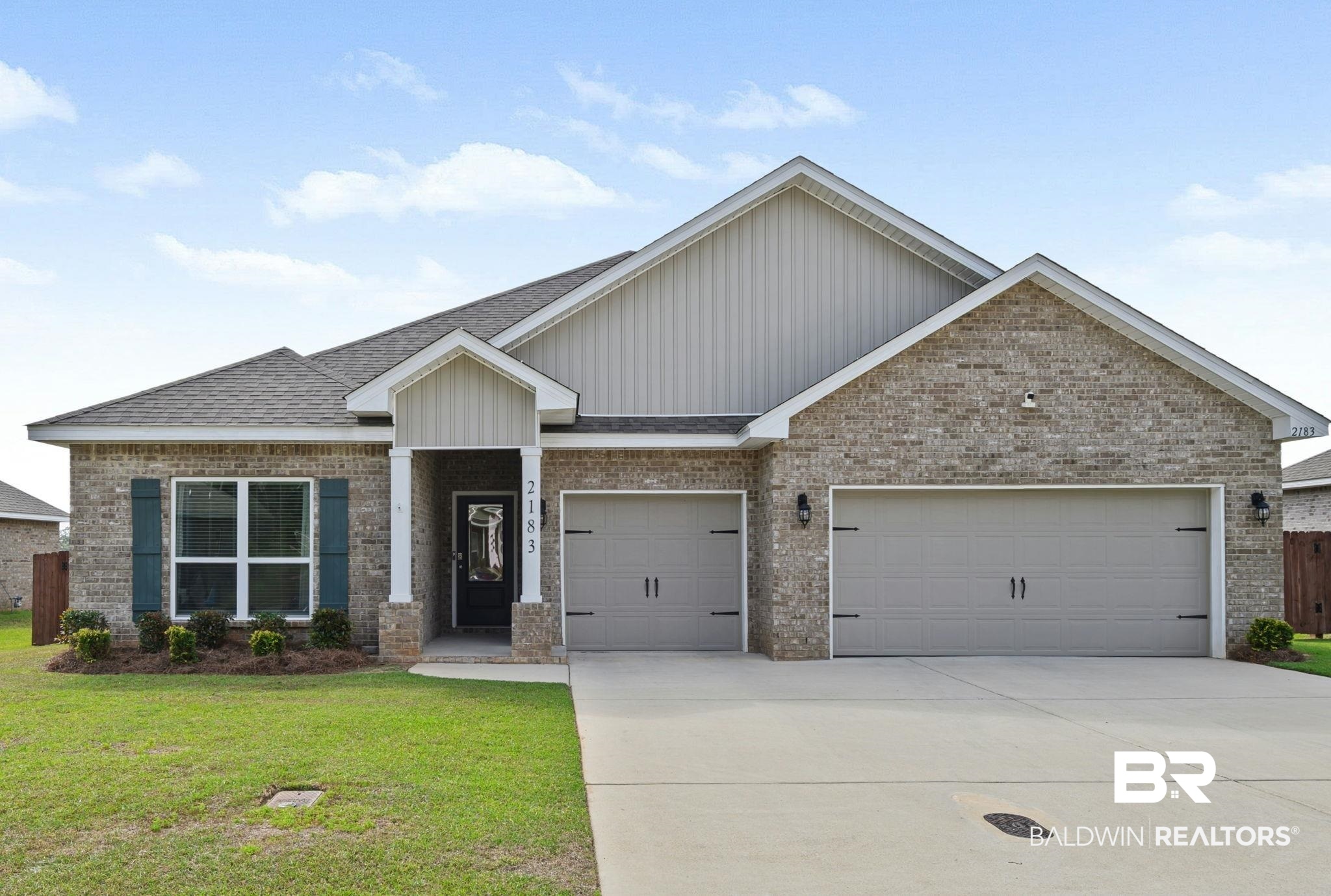 2183 Meadowview Loop Semmes, AL 36575 - Photo 1 of 58 View of front of property featuring brick siding, driveway, roof with shingles, board and batten siding, and a front lawn