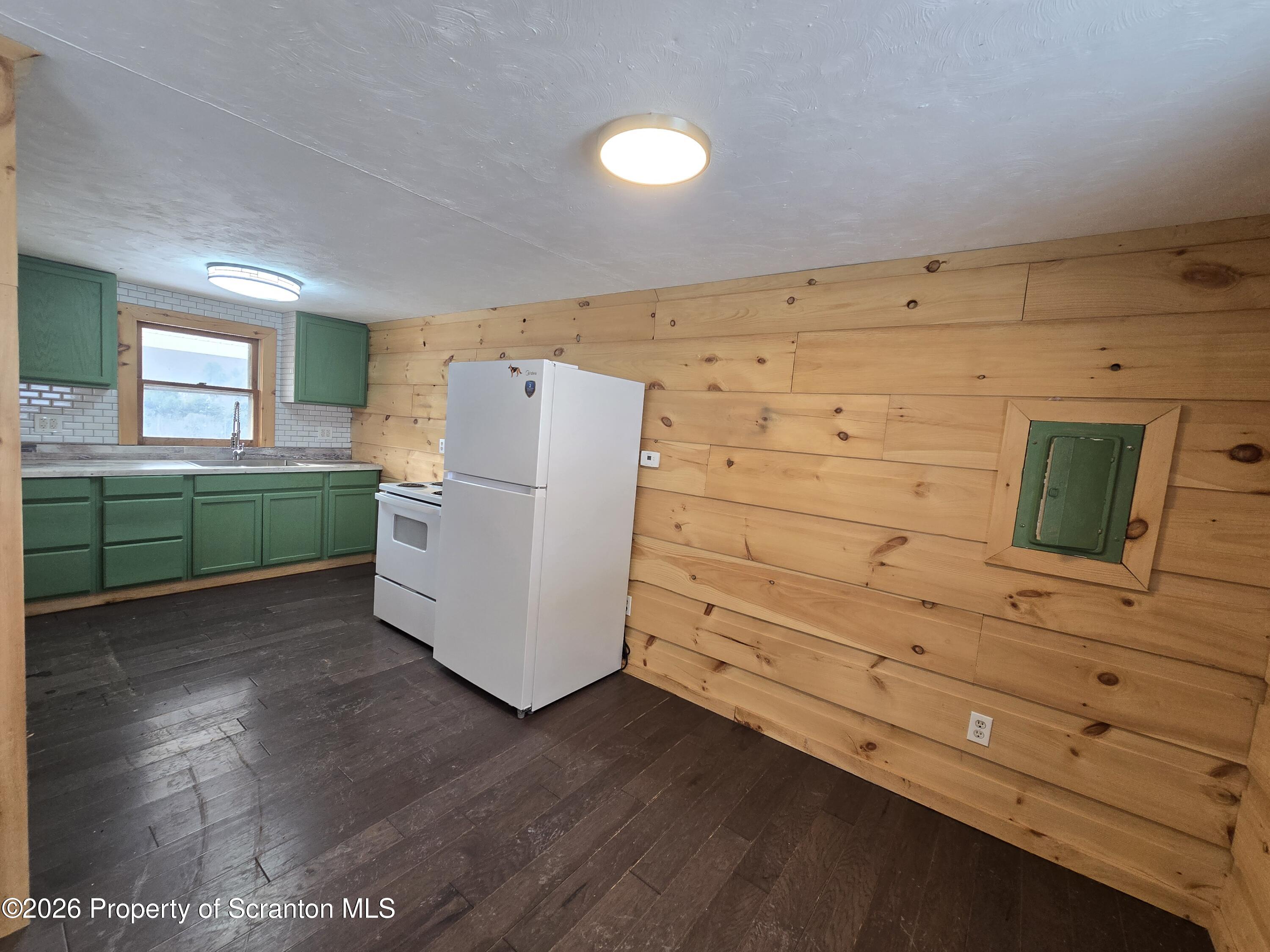 483 Turnpike Street Susquehanna, PA 18847 - Photo 16 of 27 a utility room with cabinets and wooden floor