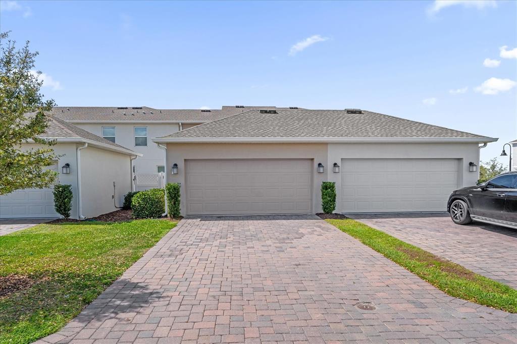 2959 Addison Boulevard St. Cloud, FL 34771 - Photo 23 of 30 a front view of a house with a yard and garage