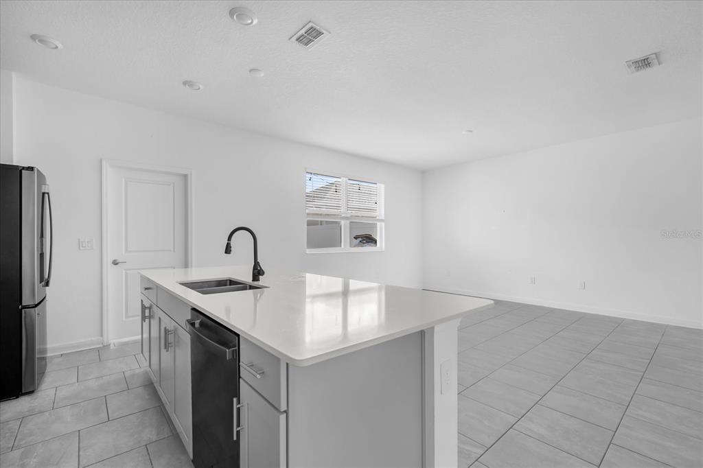 2959 Addison Boulevard St. Cloud, FL 34771 - Photo 6 of 30 a kitchen with a sink cabinets and refrigerator