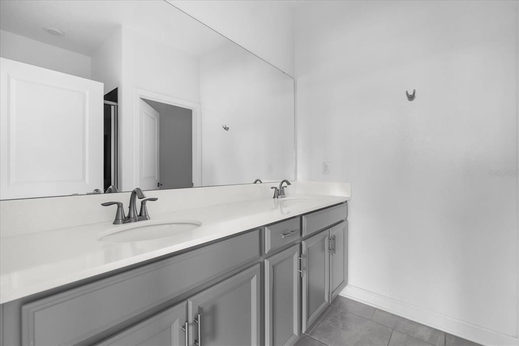 2959 Addison Boulevard St. Cloud, FL 34771 - Photo 10 of 30 a bathroom with a sink and a mirror