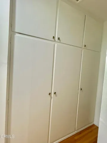 a front view of a house with a tree