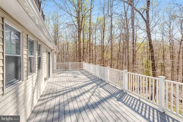 a view of a balcony with wooden floor and fence