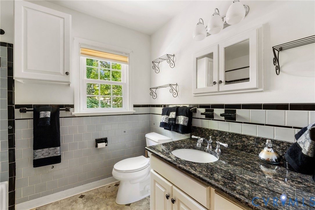 3369 Warner Road Richmond, VA 23225 - Photo 17 of 46 a bathroom with a granite countertop sink and a toilet