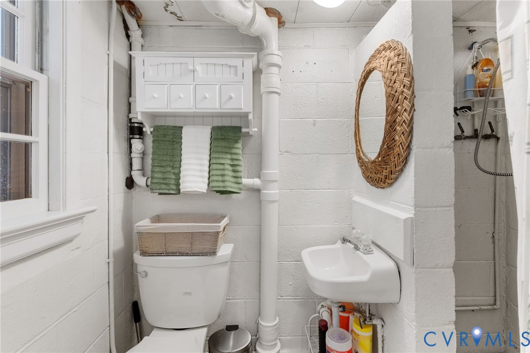 3369 Warner Road Richmond, VA 23225 - Photo 20 of 46 a bathroom with a toilet sink and mirror