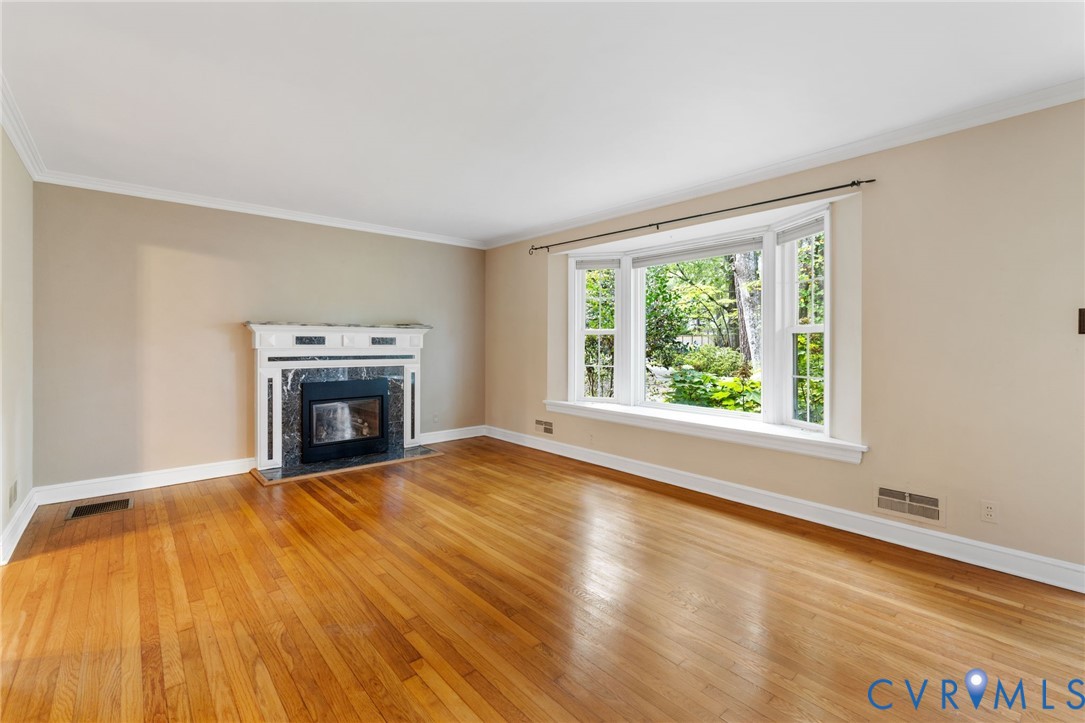 3369 Warner Road Richmond, VA 23225 - Photo 4 of 46 a view of empty room with wooden floor and fireplace