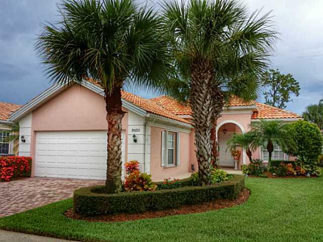 9520 Southwest Wedgewood Lane, Unit 9520 Stuart, FL 34997 - Photo 1 of 1 a front view of house with small garden and palm tree