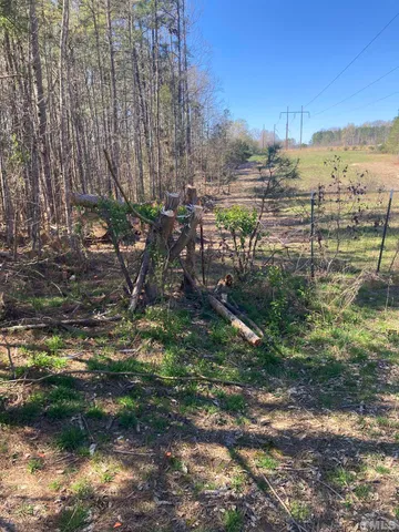 a view of a yard with wooden fence