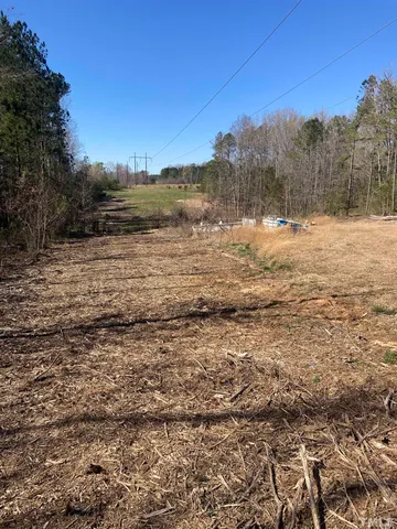 a view of a yard with wooden fence