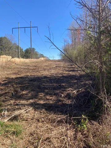 a view of a yard with wooden fence