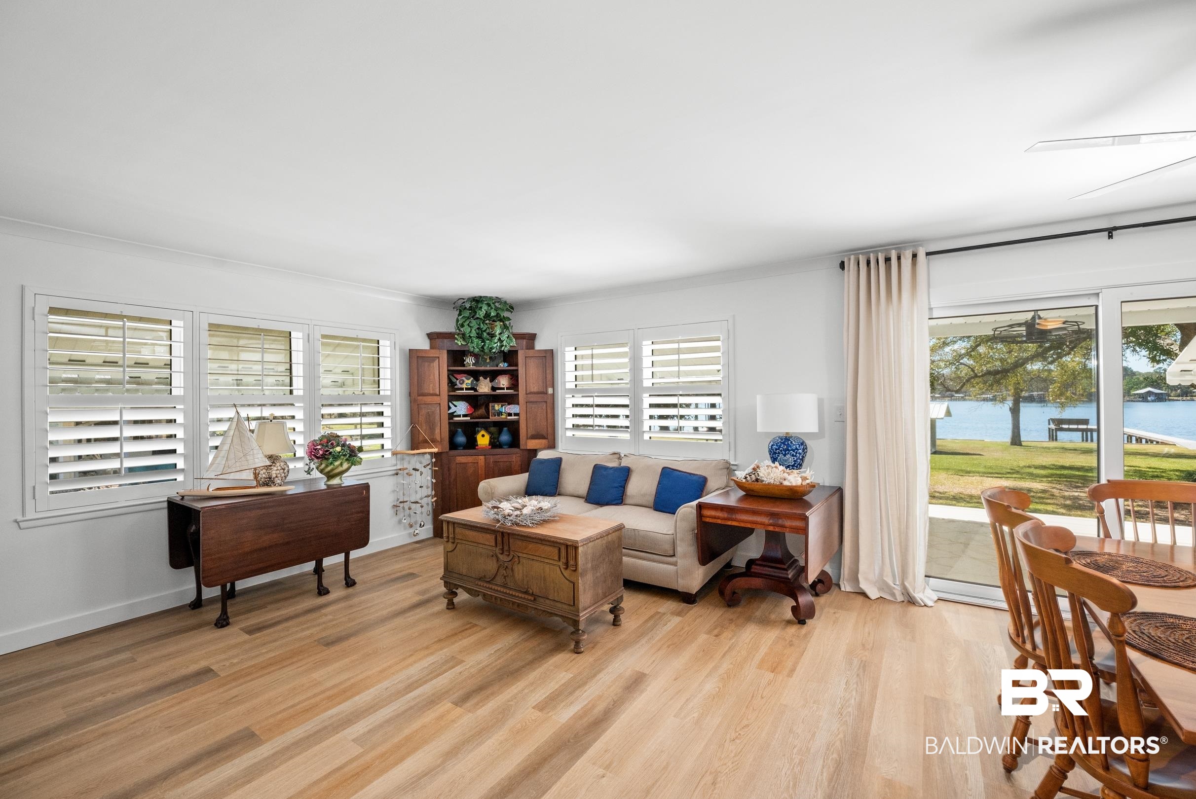 9459 Soldier Creek Road Lillian, AL 36549 - Photo 5 of 54 Living room featuring a water view, light wood-style flooring, and baseboards