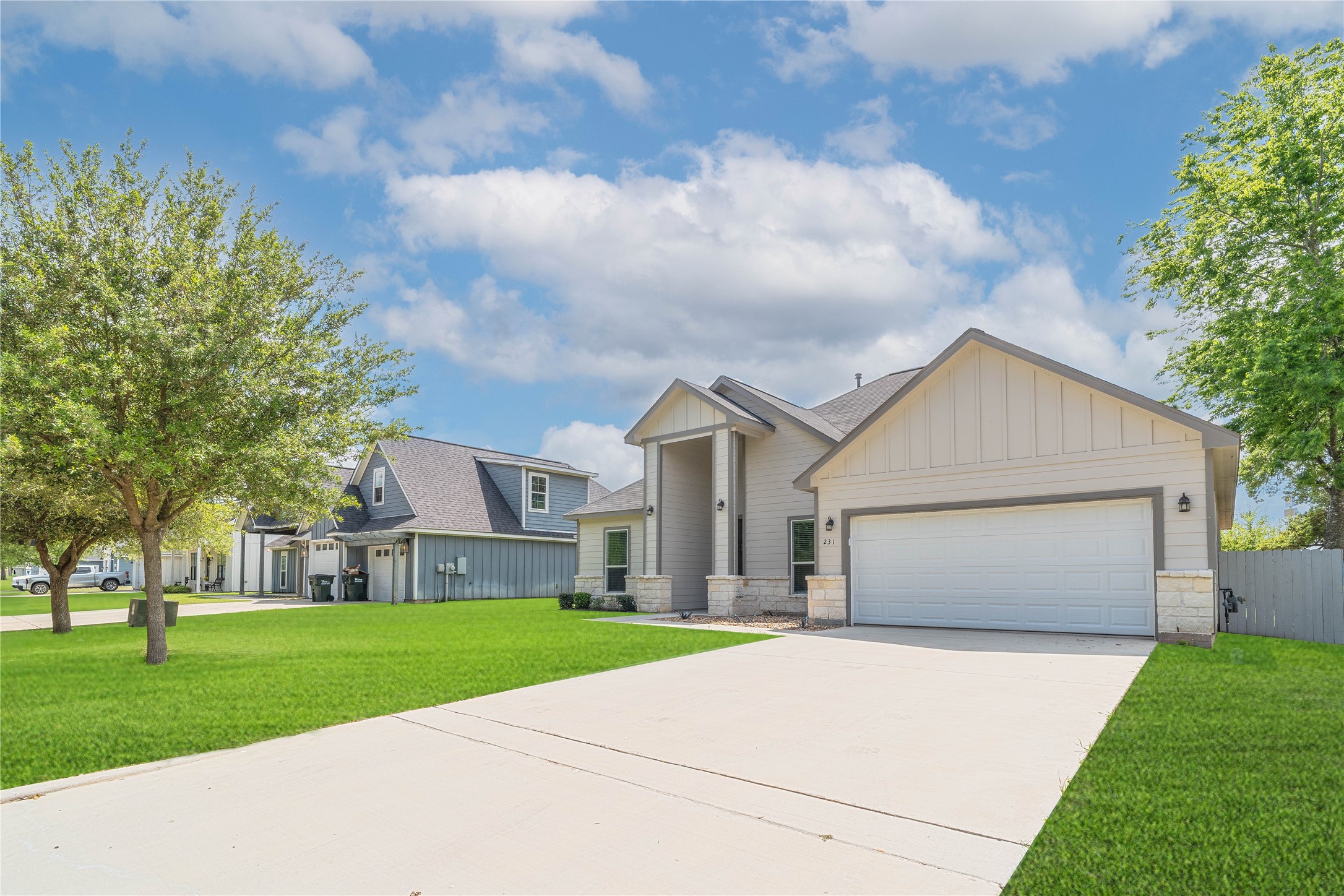 231 McCormick Street Columbus, TX 78934 - Photo 2 of 27 Front Exterior – Another view of the home’s curb appeal featuring a well-maintained lawn and spacious driveway.