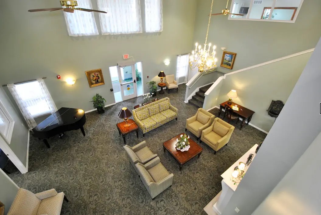 1320 Ashebury Lane Howell, MI 48843 - Photo 2 of 8 a living room with furniture and a chandelier