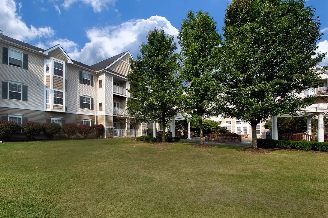 1320 Ashebury Lane Howell, MI 48843 - Photo 4 of 8 a view of a building with a yard