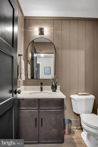 a bathroom with a toilet sink and mirror