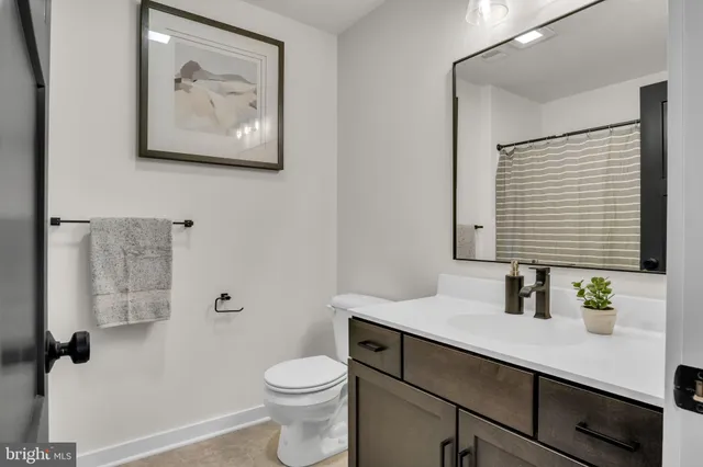 a bedroom with a bed and a dresser with mirror