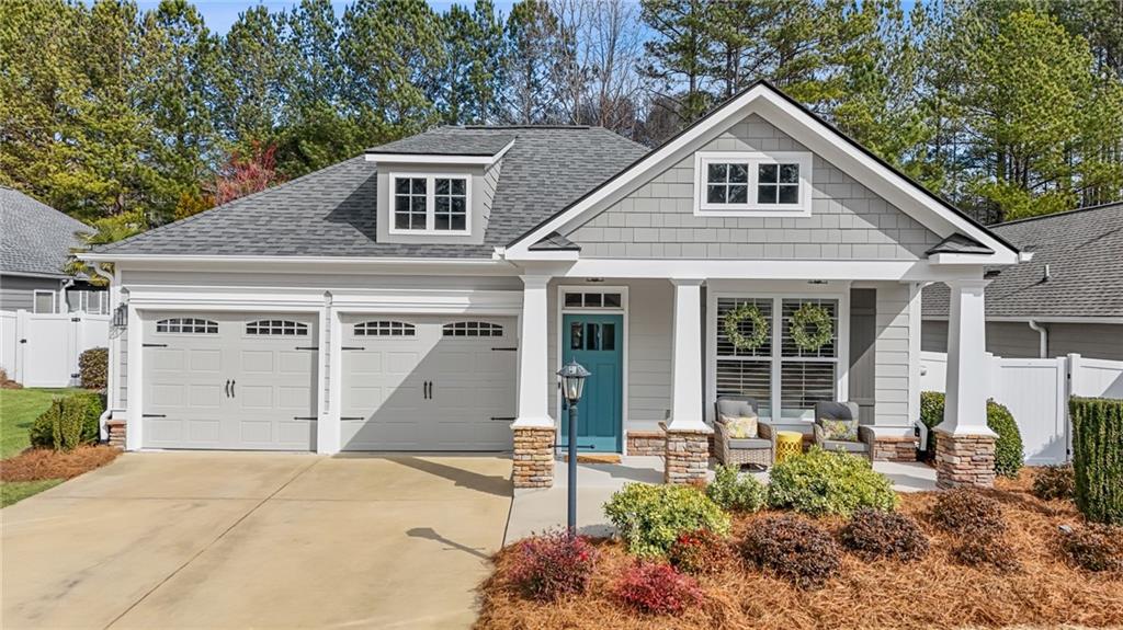 a view of a house with a yard and potted plants