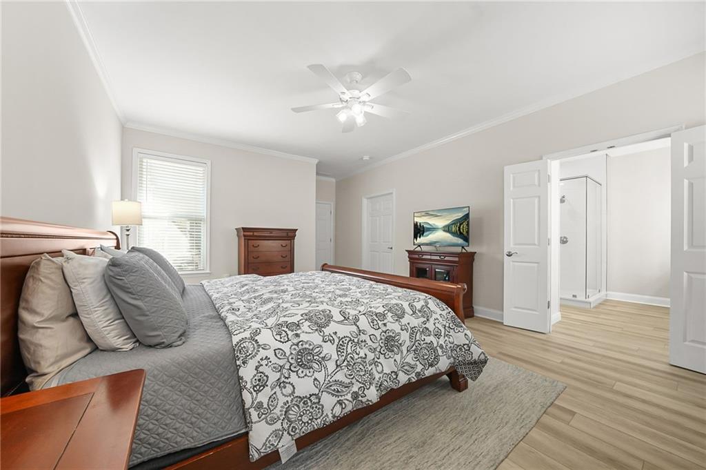 356 Shoal Creek Way Dallas, GA 30132 - Photo 12 of 32 a bedroom with a bed and wooden floor