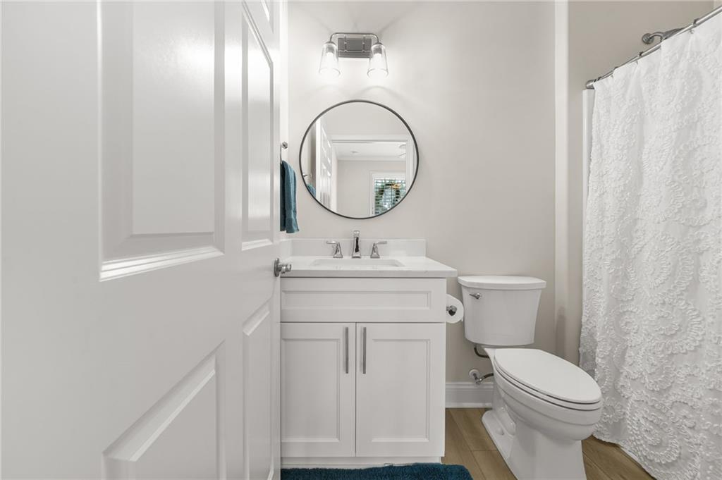 356 Shoal Creek Way Dallas, GA 30132 - Photo 14 of 32 a bathroom with a toilet a sink and a mirror