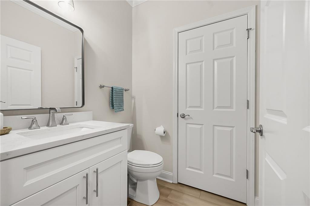 356 Shoal Creek Way Dallas, GA 30132 - Photo 16 of 32 a bathroom with a toilet a sink and mirror