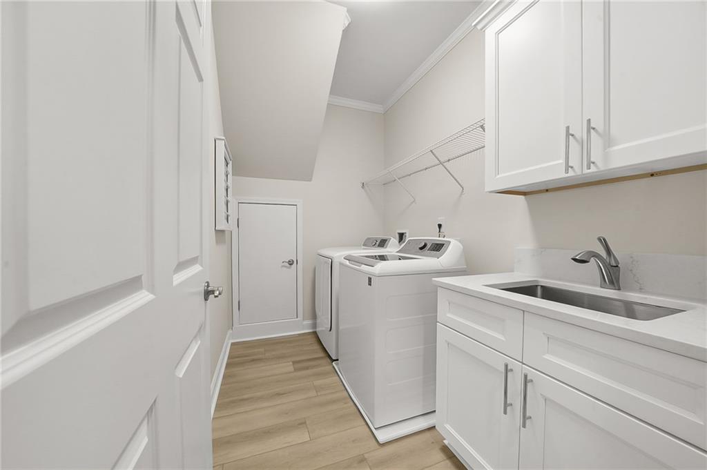 356 Shoal Creek Way Dallas, GA 30132 - Photo 17 of 32 a utility room with cabinets washer and dryer