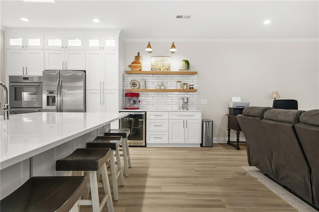 356 Shoal Creek Way Dallas, GA 30132 - Photo 4 of 32 a open kitchen with stainless steel appliances kitchen island granite countertop a refrigerator and a stove top oven