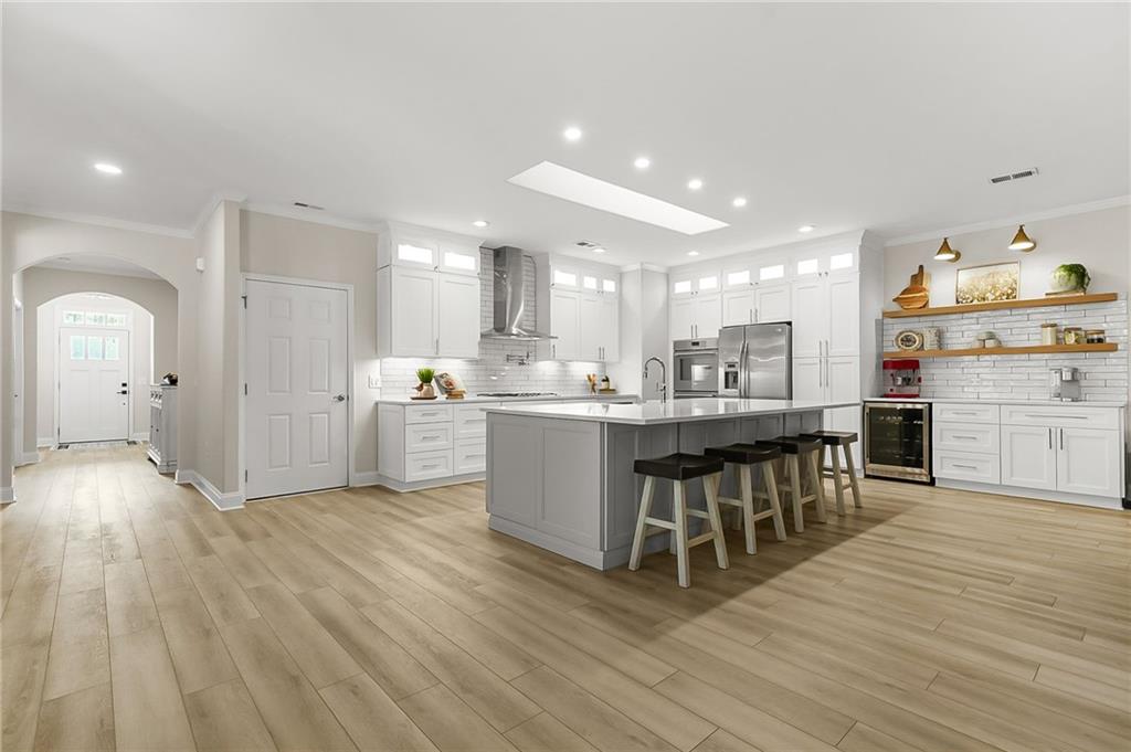 356 Shoal Creek Way Dallas, GA 30132 - Photo 6 of 32 a kitchen with stainless steel appliances granite countertop a stove a sink dishwasher and a refrigerator with wooden floor